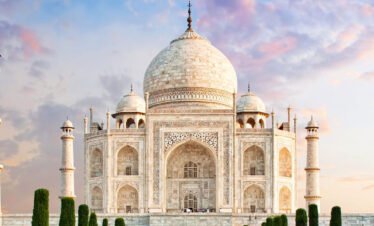 Majestic sunrise view at Taj Mahal during a Same Day Agra Tour by Car.