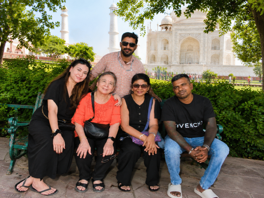 Family sitting together posing for a portrait during sunrise Taj Mahal tour packages in Agra