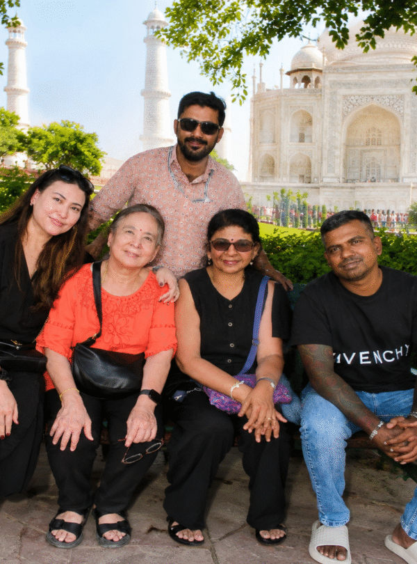 Family sitting together posing for a portrait during sunrise Taj Mahal tour packages in Agra
