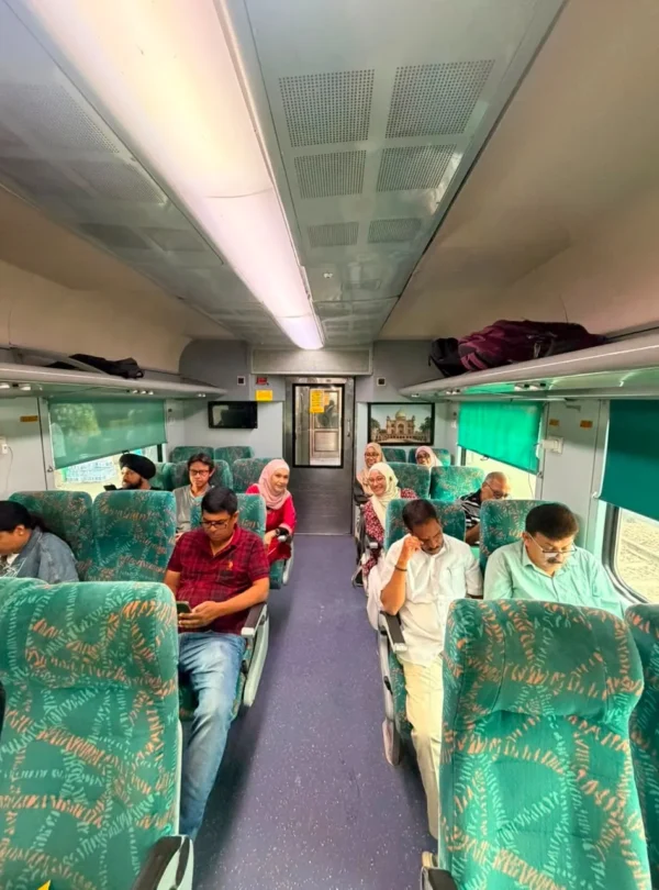 Travellers travelling on the Gatimaan Express during a Same Day Agra Taj Mahal Tour from Delhi