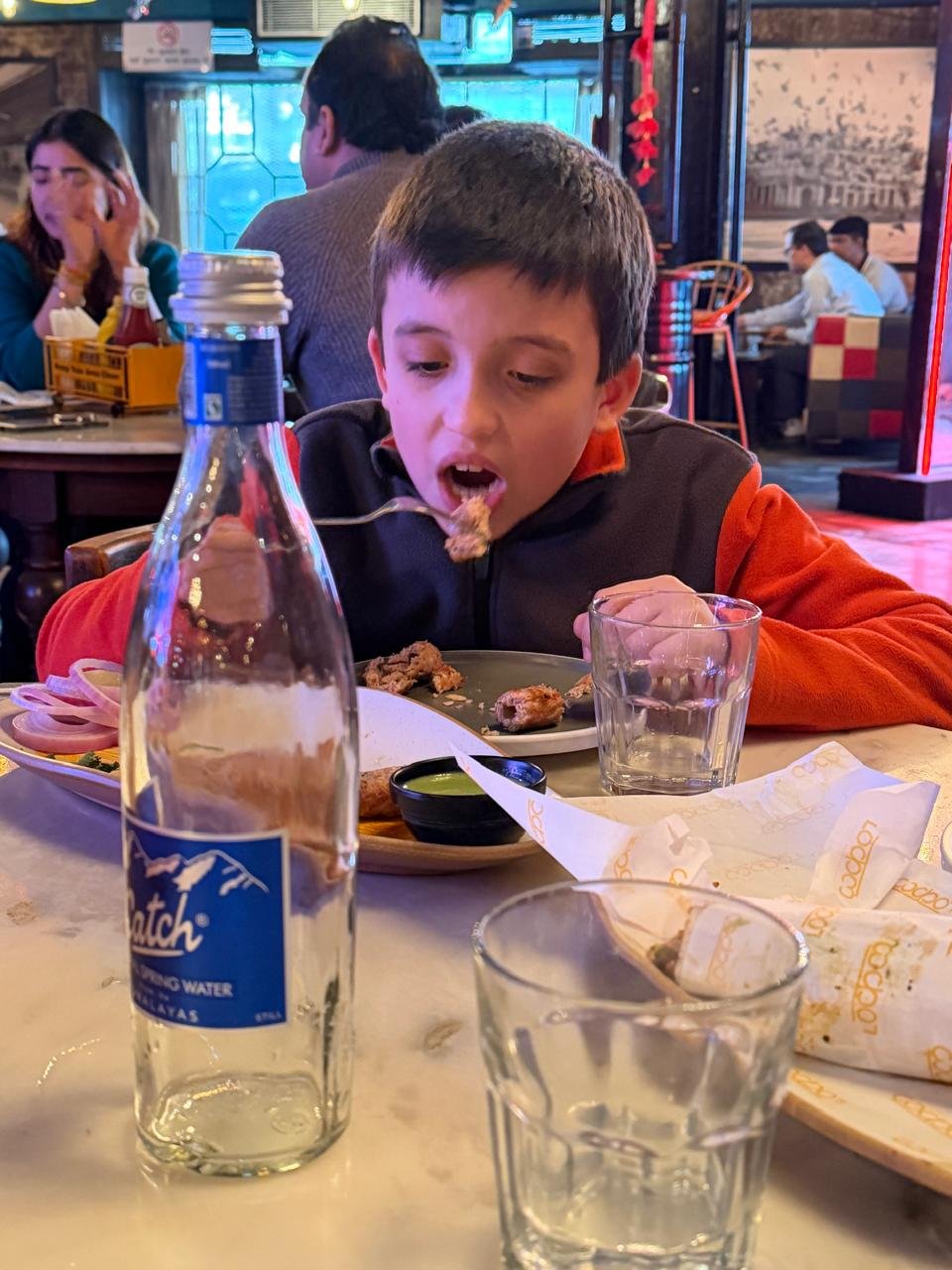 Child enjoying a meal during a same day Delhi tour by car