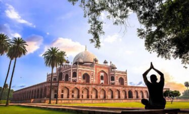 Sunrise view of the Taj Mahal in Agra, a premier destination on the 6-day Golden Triangle Tour India, showing the white marble mausoleum reflecting in the garden fountains.