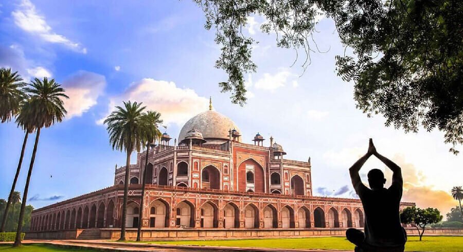 Sunrise view of the Taj Mahal in Agra, a premier destination on the 6-day Golden Triangle Tour India, showing the white marble mausoleum reflecting in the garden fountains.