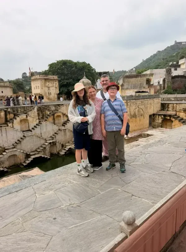 Family visiting a historic stepwell in Jaipur during a Taj Explorer tour