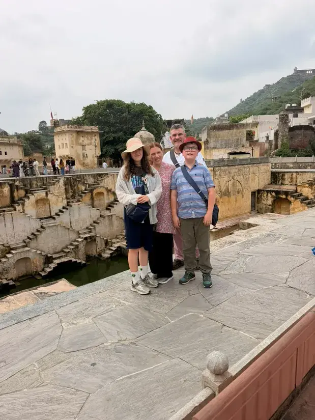 Family visiting a historic stepwell in Jaipur during a Taj Explorer tour