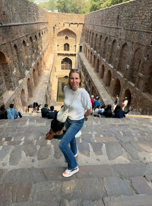 Tourist standing on the steps of Agrasen ki Baoli during a Same Day Delhi Tour By Car