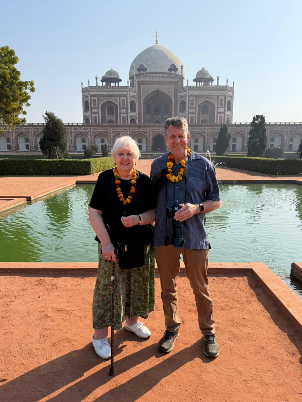 Tourists posing for a photo in front of Safdarjung Tomb during a Same Day Delhi Tour By Car