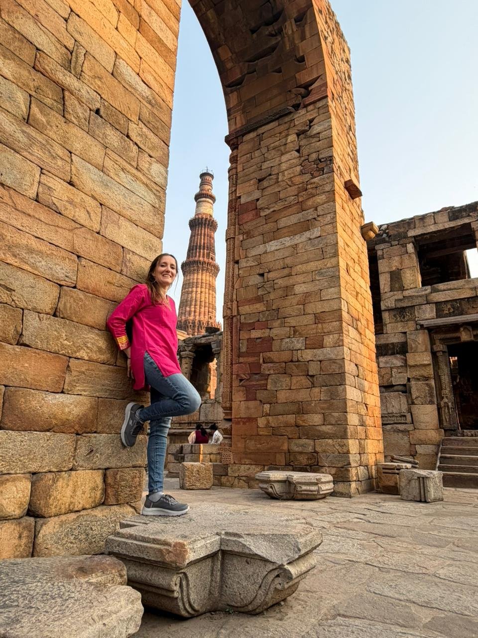 Tourist standing near historical architectural ruins during a Same Day Delhi Tour By Car