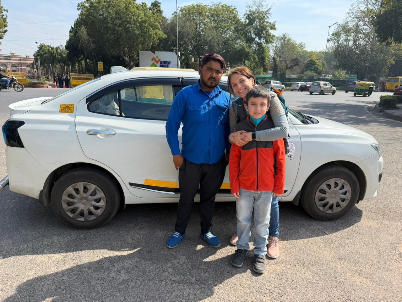Tourists posing next to a private AC sedan car during a Same Day Delhi Tour By Car