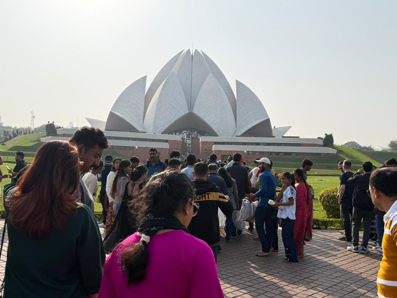 Visitors exploring Lotus Temple during a Delhi Temples Tour