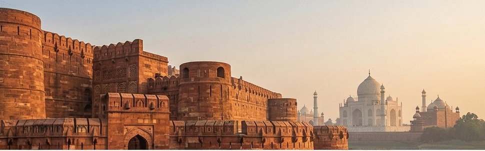 A premium Agra Fort tour showing the red sandstone architecture of the Lal Kila Agra during sunset.