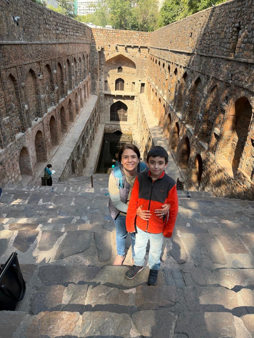 Tourists exploring the historic Agrasen ki Baoli stepwell on a Private Delhi Tour