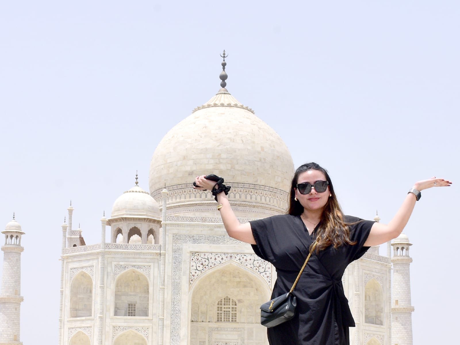 Tourist posing in front of the Taj Mahal in Agra India