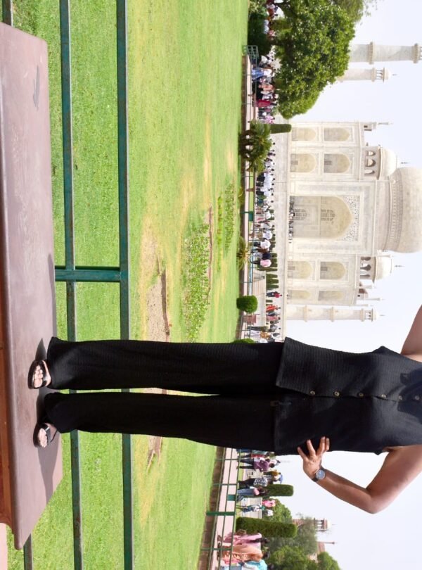 Tourist posing creatively in a gateway arch during a sunrise Taj Mahal tour