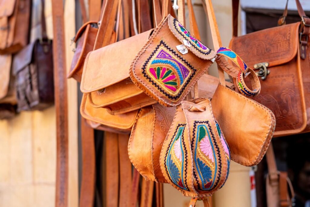 Handcrafted Indian leather bags displayed in a traditional artisan market, one of the best gifts from India.