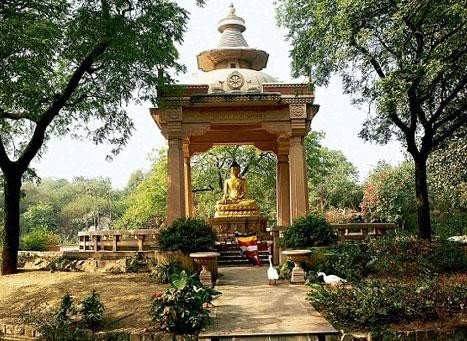 15 Best Parks in Delhi for Nature, Morning Walks and Sightseeing 9 Parks in Delhi featuring the Buddha statue beneath a stone pavilion at Buddha Jayanti Park